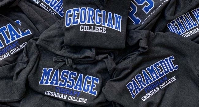 Stack of all Georgian college program hoodies